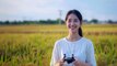 young women asian smile holding joy controller drone in in the middle of a rice field cinematography,Midjourney prompts