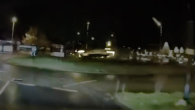 Moment speeding car flies over roundabout