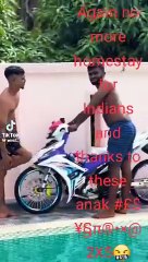 Young boys revving their motorcycles by the pool