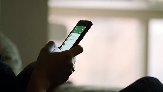 Hand texting on smartphone