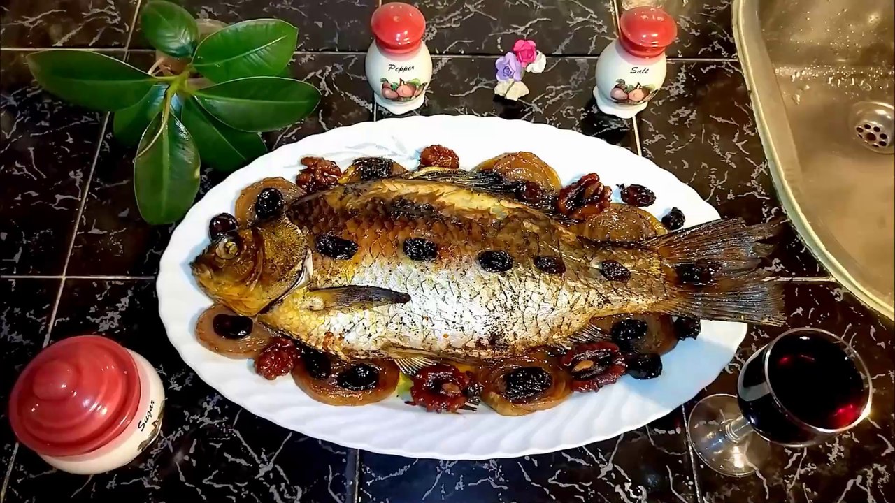 Baked Caracuda (Carassius) stuffed with walnuts and raisins