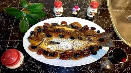 Baked Caracuda (Carassius) stuffed with walnuts and raisins