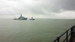 Royal Navy warship HMS Tyne sails into Portsmouth during rain showers
