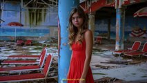 Total front shot capturing the teenager with a red dress at an abandoned beach facility with sunbeds,Midjourney prompts