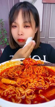 CHINESE EATING SPICY NOODLES