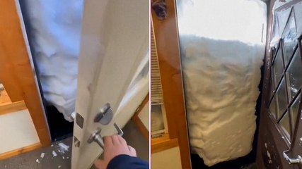 Wall of snow blocks office door at California ski resort during severe storm