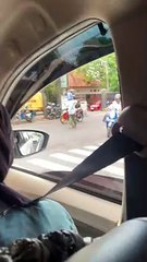 Man Directing Traffic Wears Water Jug in Indonesia