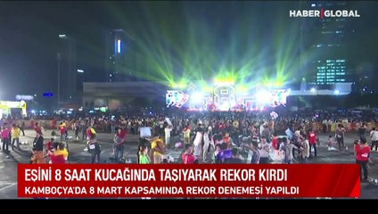 Eşini 8 saat kucağında taşıyarak rekor kırdı