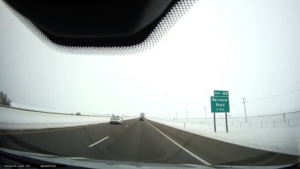 Passing Car Hits Ice and Rolls Into Ditch