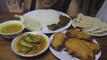 EATING DAL, FISH IN TOMATO GRAVY, BAIGAN PAKODE, CHAPATI, WHITE RICE, PAPPAD FRY, BAIGAN FRY, FISH MASALA