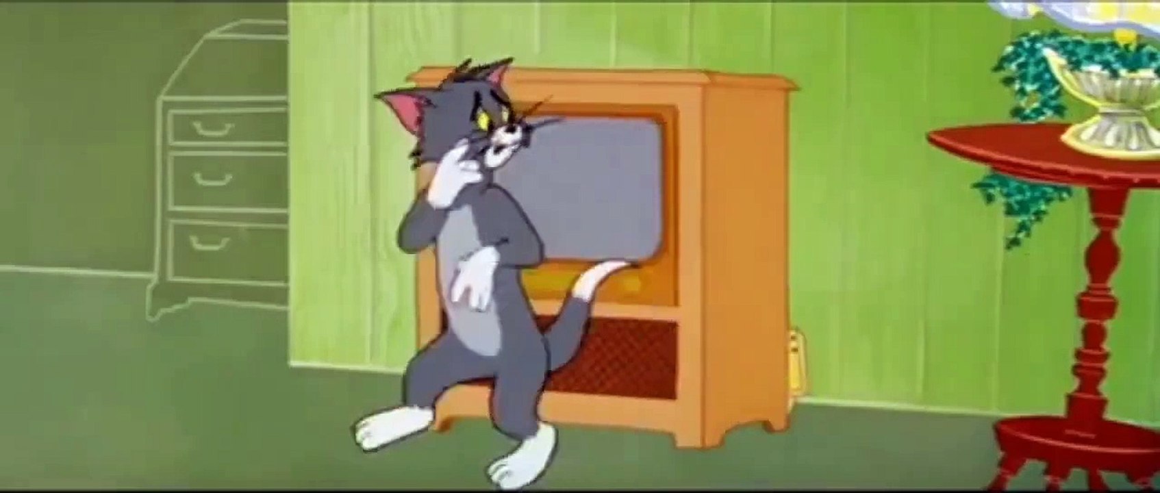 tom watching funny video in tv