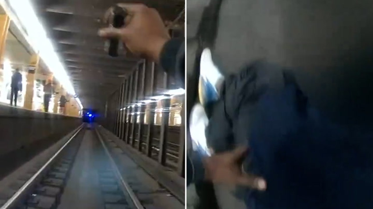 Watch: NYPD officers jump onto subway tracks to rescue man as train approaches