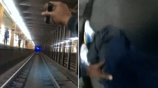 Watch: NYPD officers jump onto subway tracks to rescue man as train approaches
