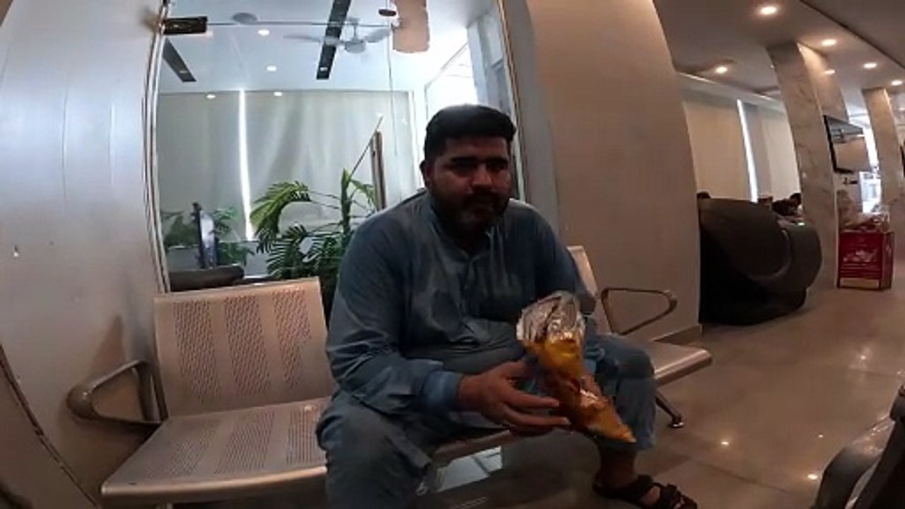 Fat boy eating chips lays