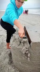 "Watch the waves and the magic of a sand house unfold!"