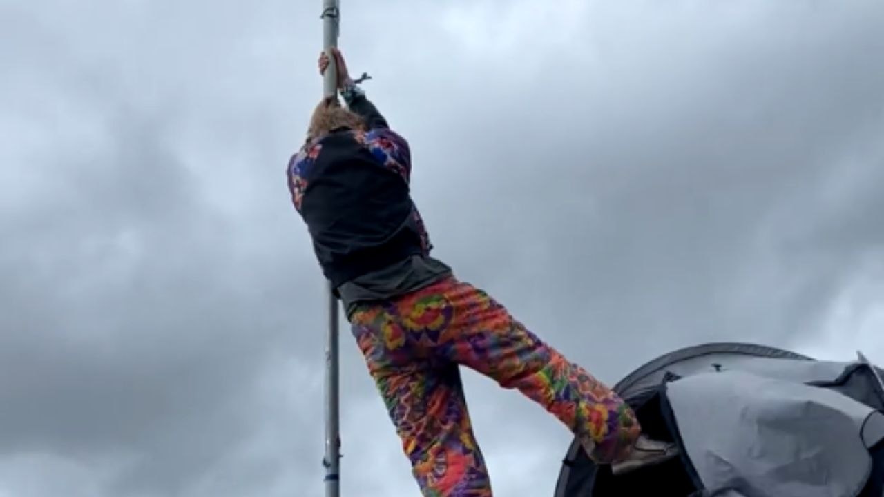 Camper balances tent on a 20foot pole to create an epic camp flag