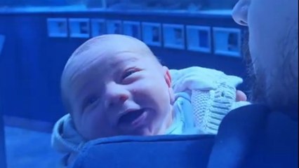 Fish fascinate newborn on his first ever visit to the aquarium