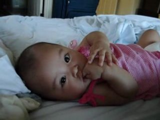 logan trying to put her pacifier in her mouth