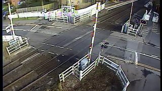 Van ploughs through level crossing