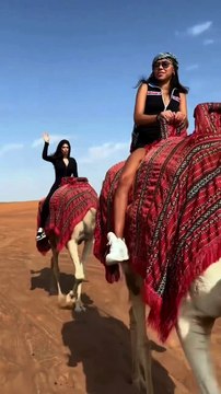 Camel riding on the sand of Abu Dubai Desert