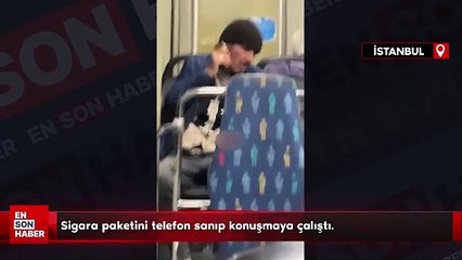 Otobüste sigara paketini telefon sanıp konuşmaya çalıştı.