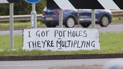 Mystery artist mocks council with signs slamming pothole problems plaguing town