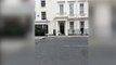 Adam Sandler slumped on pavement outside Claridge's hotel in Mayfair