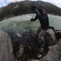 Guy Catching Fish Loses Footing on Rocks and Falls Into River