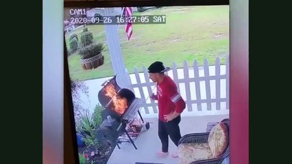 A man is cooking but the fire has moved to other  place