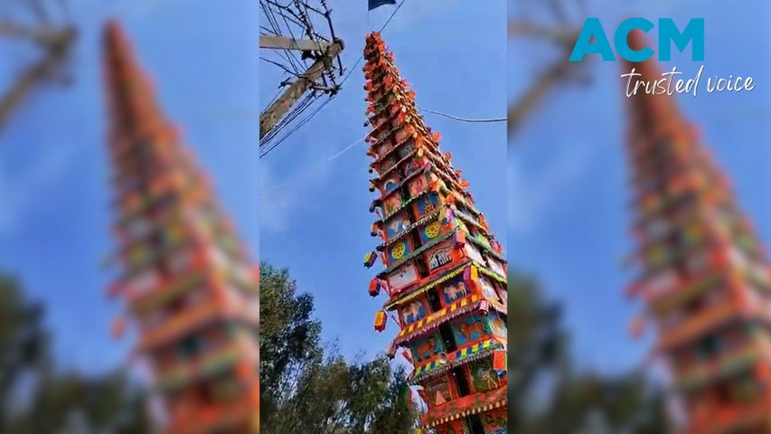 Dramatic footage shows the moment that a 120-foot temple fell over during a religious festival.