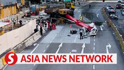 Download Video: The Straits Times | Crane topples over and crushes van in Sengkang