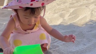 Little girl turns her mom's coffee cup into a sandbox