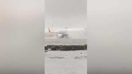Plane battles through floods at Dubai airport as heavy rain causes cancelled flights
