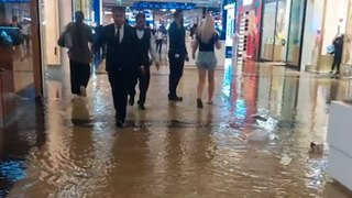 Water gushes from store's ceiling after it partially collapsed due to heavy rain