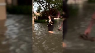 Friends wade through flood-hit Dubai