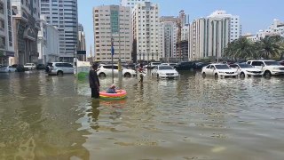 Sharjah residents use inflatables to wade through the water
