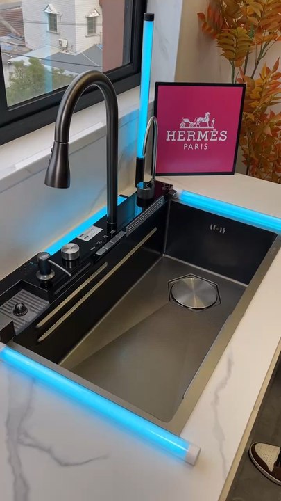 Elevate your kitchen experience with this modern sink featuring a cascading waterfall design.