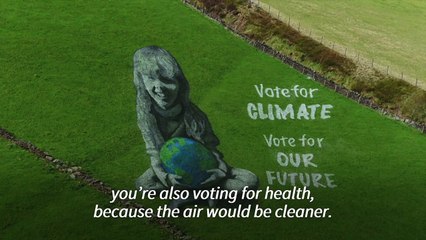 'Vote for climate' - artists paint UK hillside for Earth Day