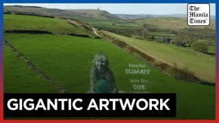 Artists paint UK hillside for Earth Day