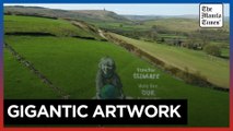 Artists paint UK hillside for Earth Day