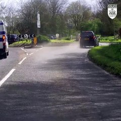 Car with shredded front tyre crashes into hedge