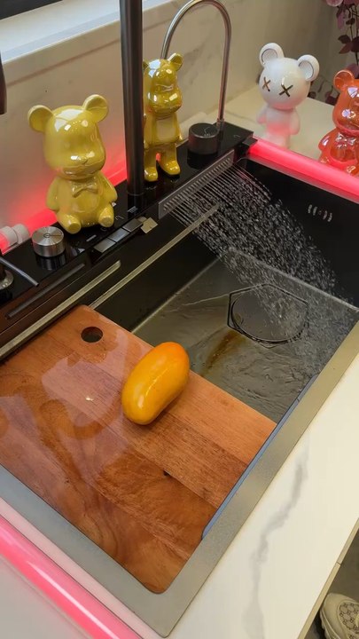 Transform your kitchen into a modern oasis with this luxurious waterfall-style sink.
