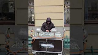 Man Plays Music with Crystal Glass on Street