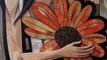 A closeup of a beautiful woman holding a large orange flower. Fibonacci sequence,Midjourney prompts