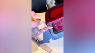 Beautician repairs friends broken car brake light using nail extensions