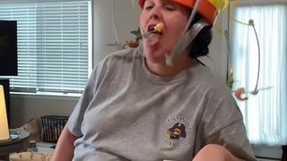 Woman Makes Funny Faces While Trying to Catch Food Hanging in Front of Her Face