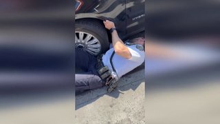 Policeman rescues kitten stuck behind car wheel in New York