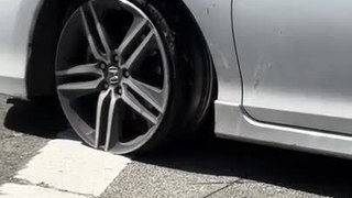 Woman Drives Car With Flat Tire