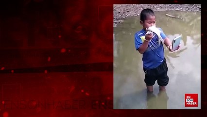 Balık yerine telefonunu nehre atan sevimli çocuk kamerada