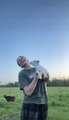 Young Woman Dances With Adorable Baby Goat